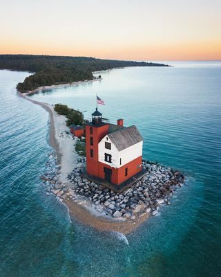 For 122 years, Round Island Lighthouse has stood stoic against the wind and weather in the Straits of Mackinac. Completed in 1895, the iconic Great Lakes beacon was originally manned by a crew of three. From 1924 to 1947, a sole light keeper occupied and operated the light station. When an automated beacon was constructed off the shore of Mackinac Island in 1947, the lighthouse was abandoned. The Round Island Lighthouse Preservation Society now maintains the lighthouse and offers an open house once a year to the public. 📸: ryanresatka #PureMichigan #MackinacIsland #LakeHuron #michiganlighthouse #roundislandlighthouse  #MyMackinac mackinacisle